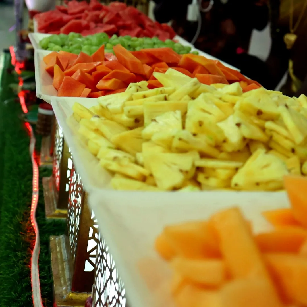 Cut fruit counter with a wide arrangement of sliced fruit at a Chennai event