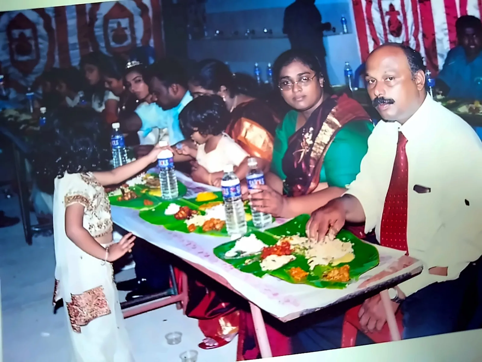 Family seated for a traditional vegetarian sappadu at a Chennai function
